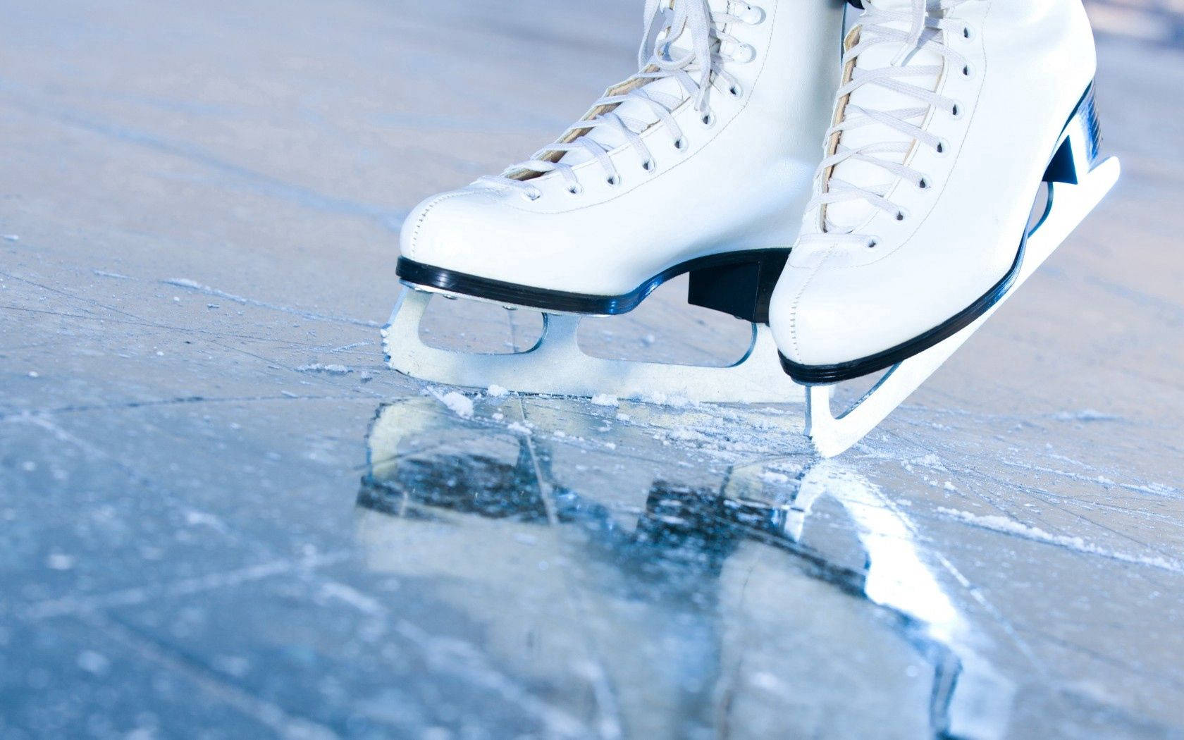 White Figure Skates On Ice Background