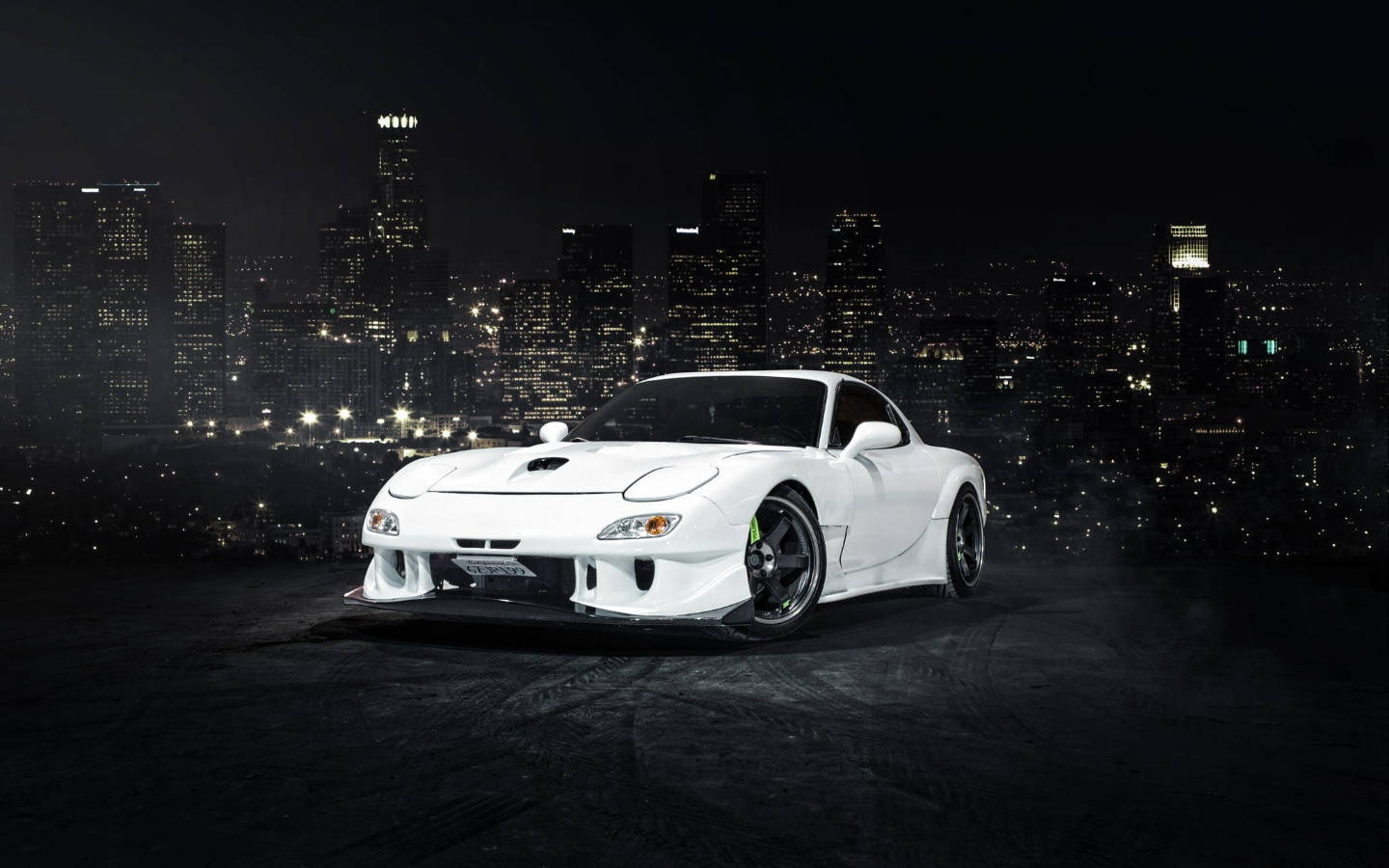 White Mazda Rx7 Overlooking City Background