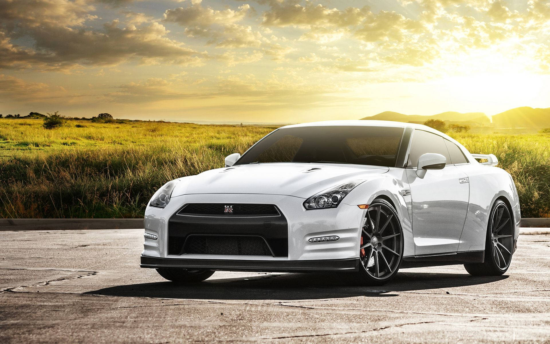 White Nissan Gtr Car Near The Green Field Background