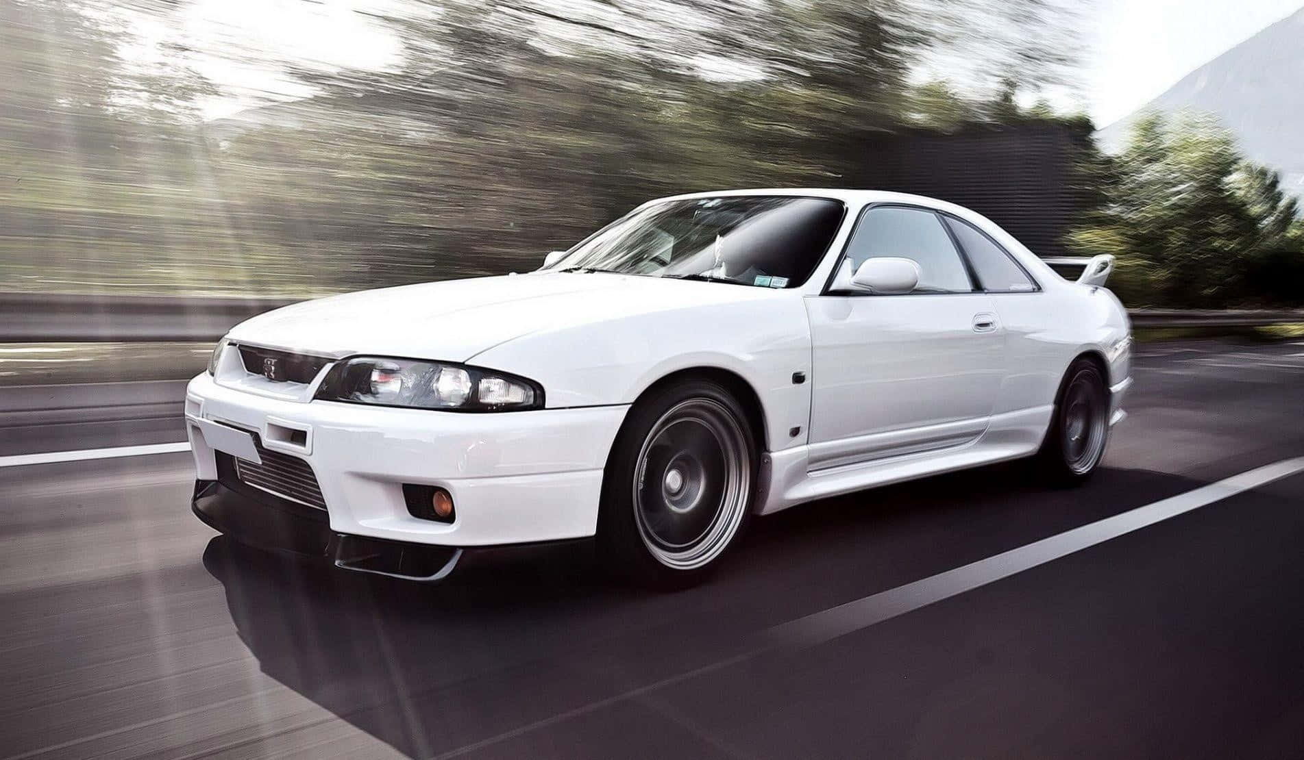 White Nissan R33 Gtr Driving Fast Background