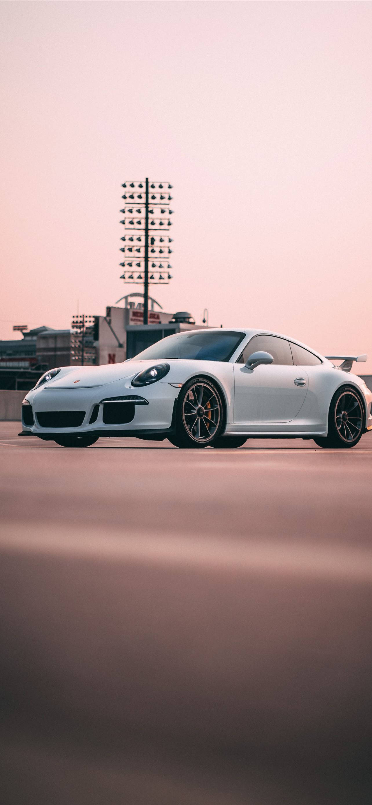 White Porsche 911 In Outdoor Parking Background