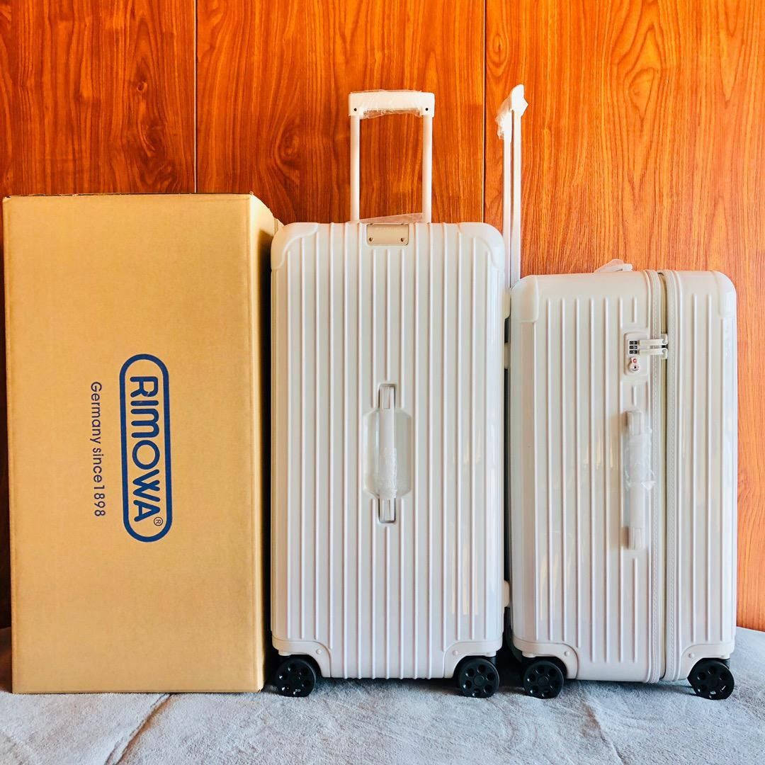 White Rimowa Suitcases Background