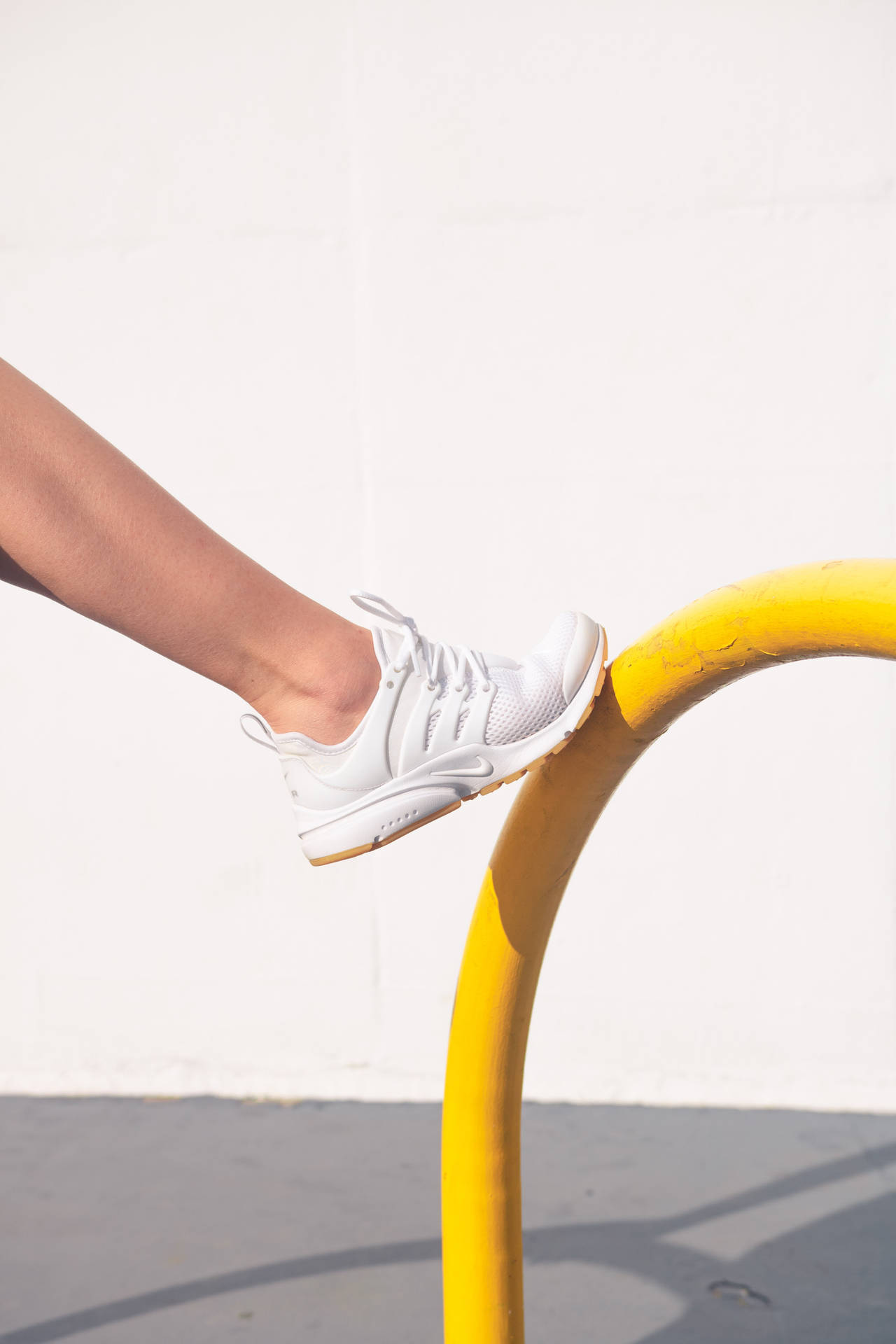 White Rubber Shoes In Yellow Tube Background