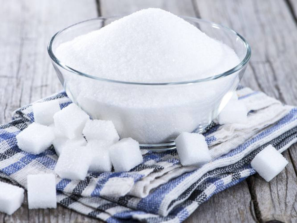 White Sugar In A Bowl And Sugar Cubes Background