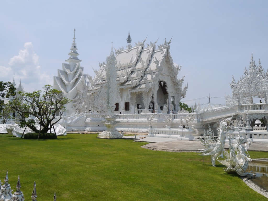 White Temple In Chiang Rai On Top Of A Mountain Background