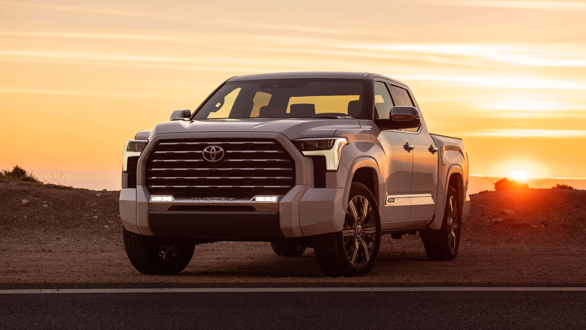 White Tundra Car With Sunset Background