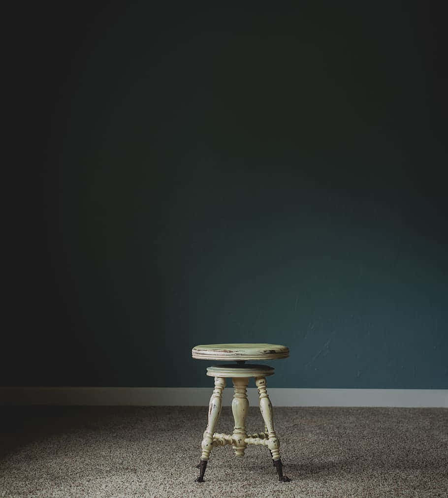 White Wooden Stool Chair In Dark Room Background