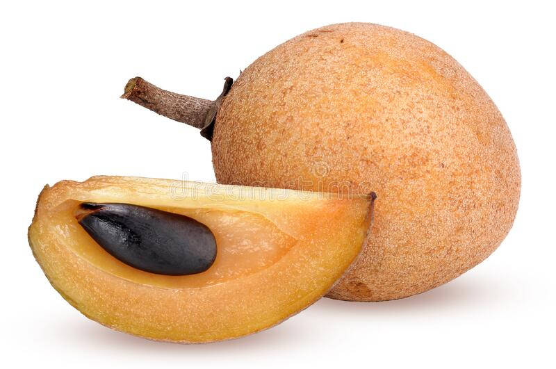 Whole And Sliced Sapodilla Fruit On A Wooden Table Background