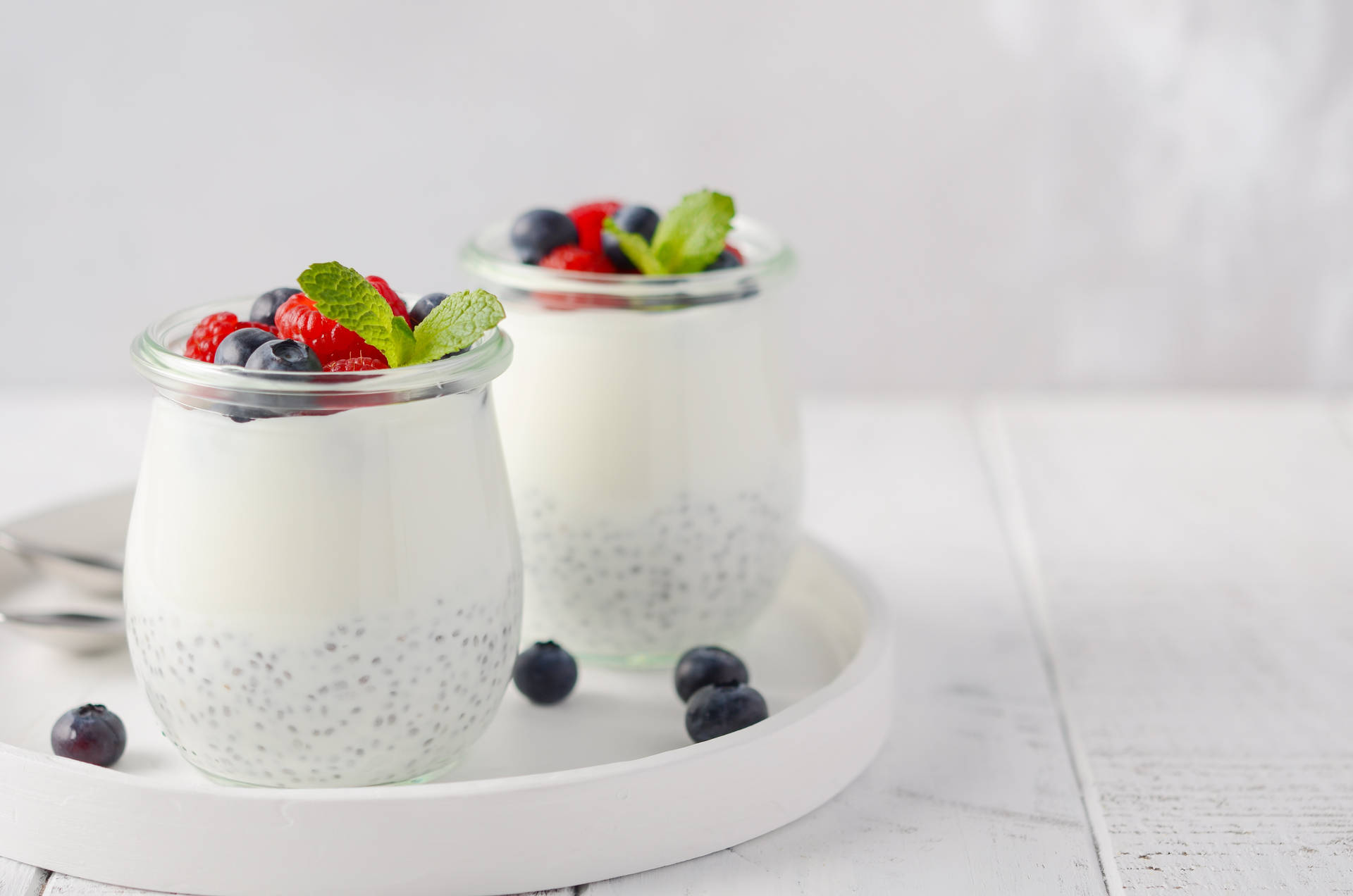 Wholesome Yogurt With Fresh Blueberries And Raspberries Background