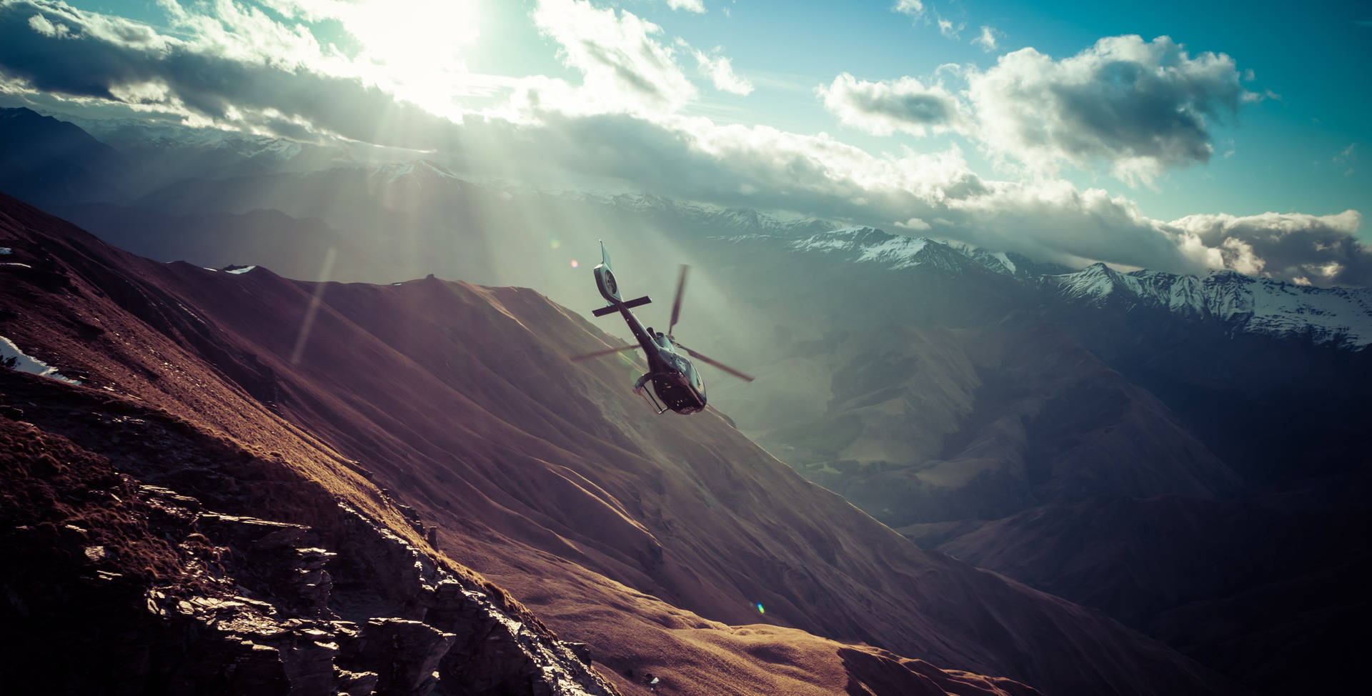 Widescreen Helicopter In The Mountains Background