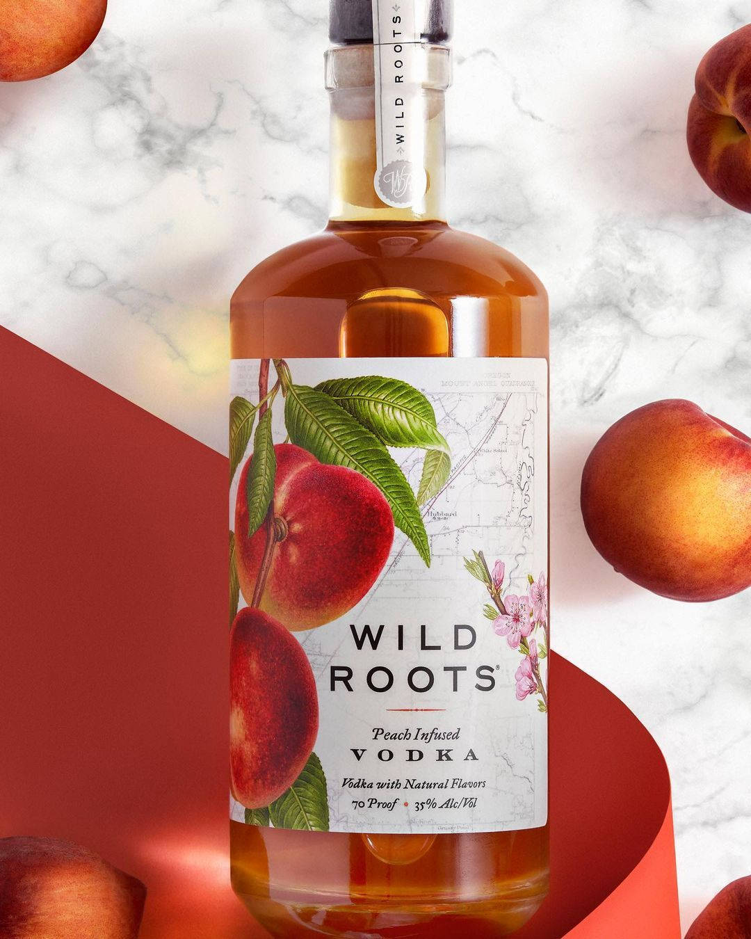 Wild Roots' Huckleberry-infused Vodka Bottle Showcasing Natural Ingredients