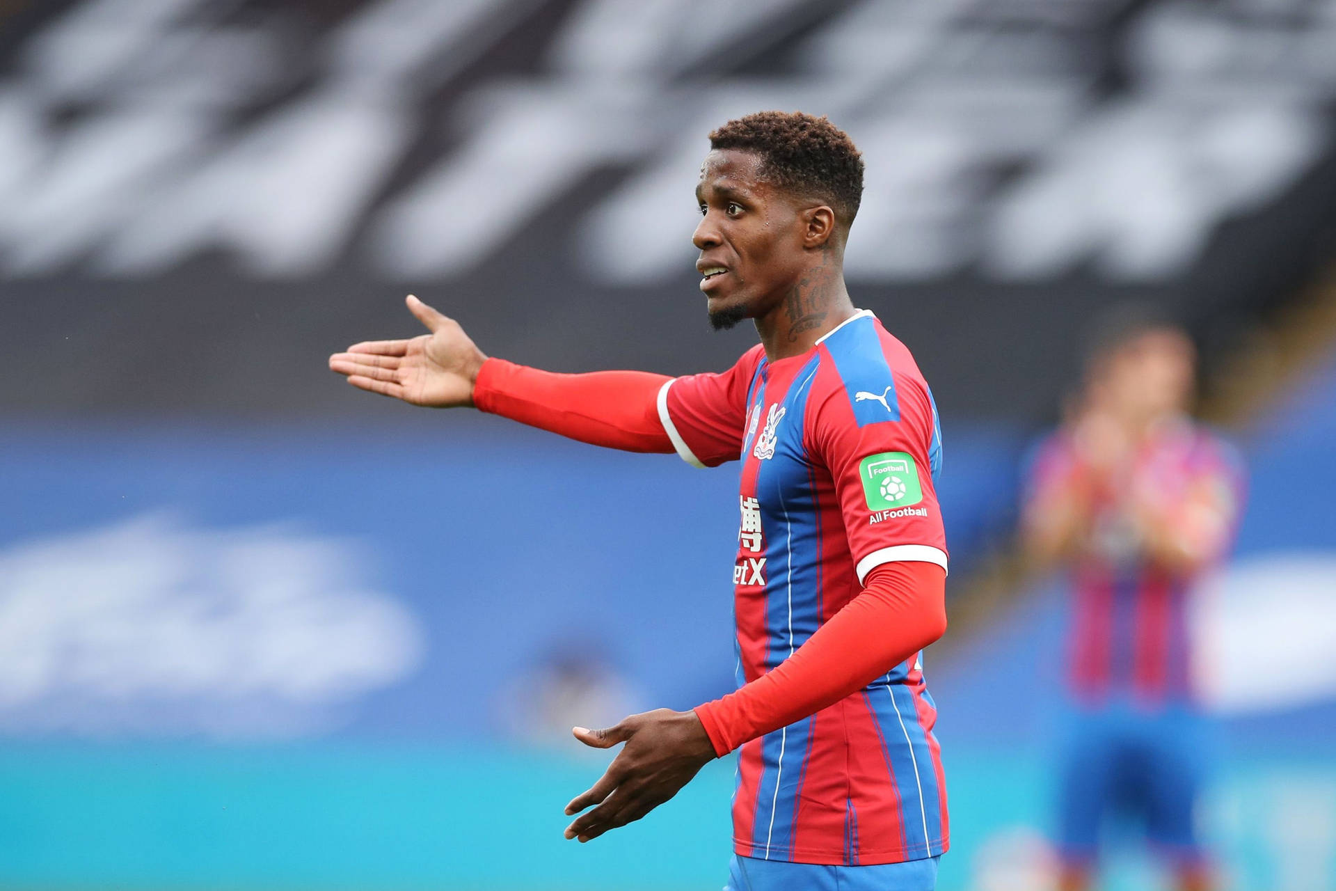 Wilfried Zaha Gesturing With His Hands Background