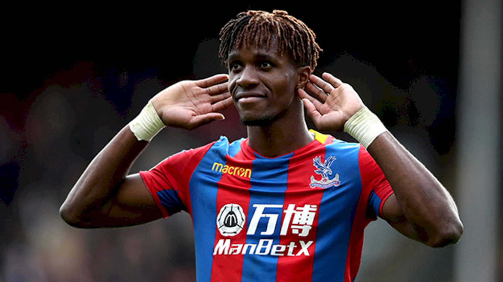 Wilfried Zaha Holding Hands To Ears Background