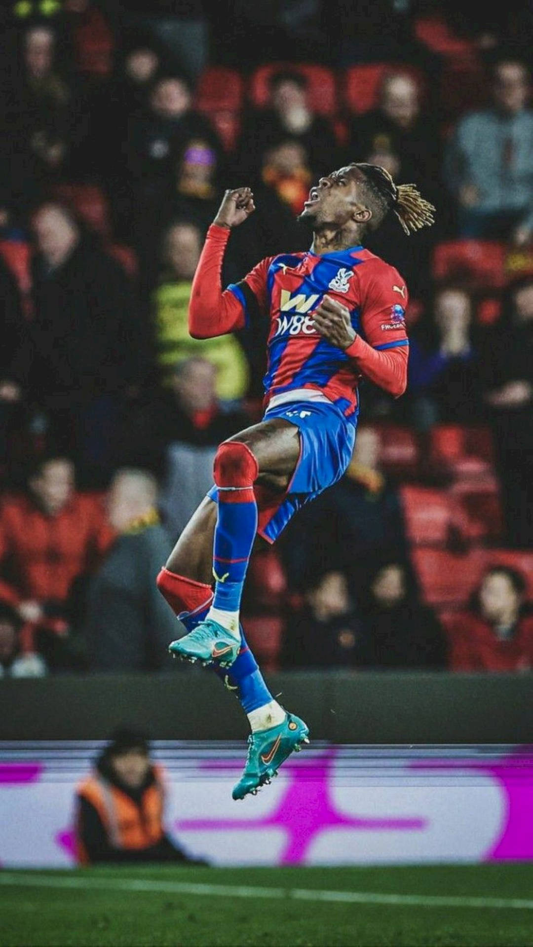 Wilfried Zaha Jumping High On Field Background