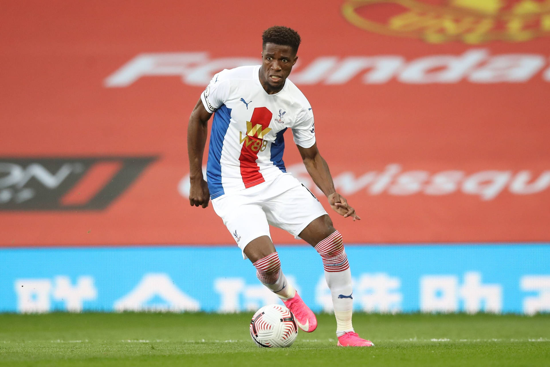 Wilfried Zaha Kicking Football Background