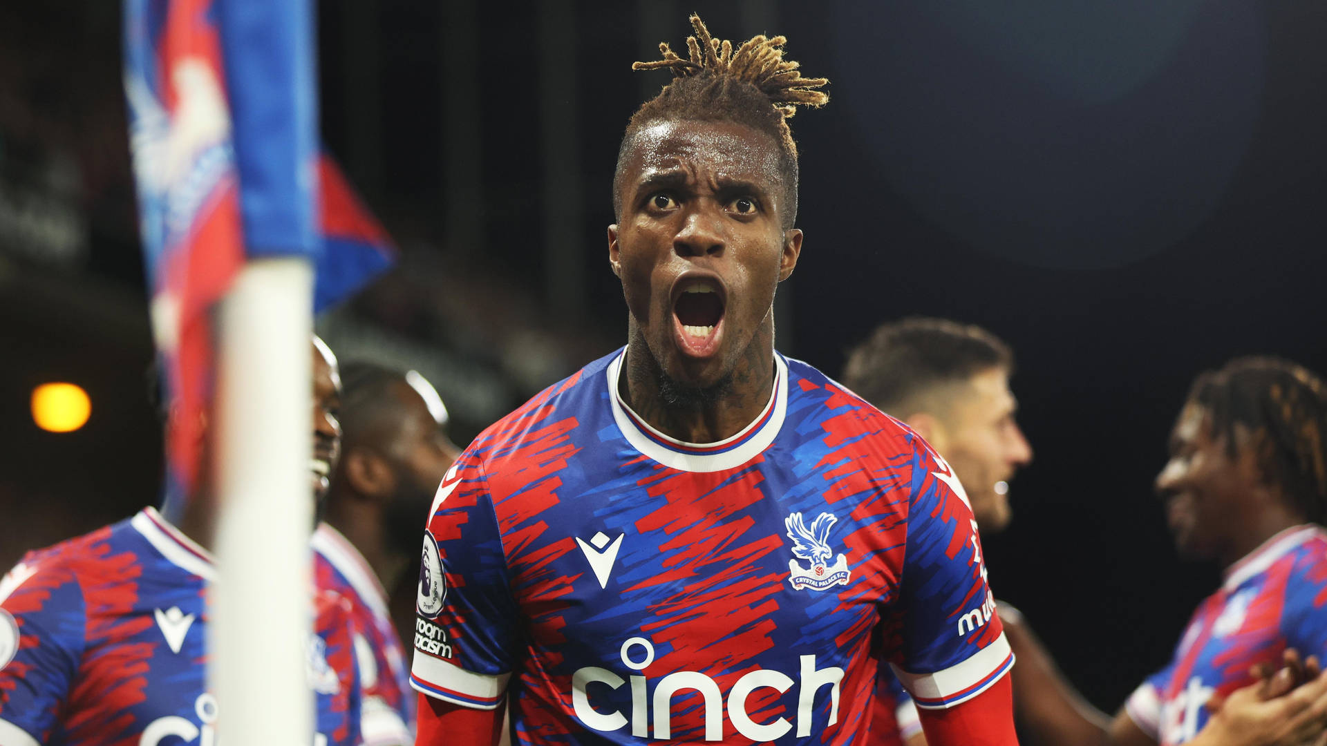 Wilfried Zaha Shouting With Teammates Background