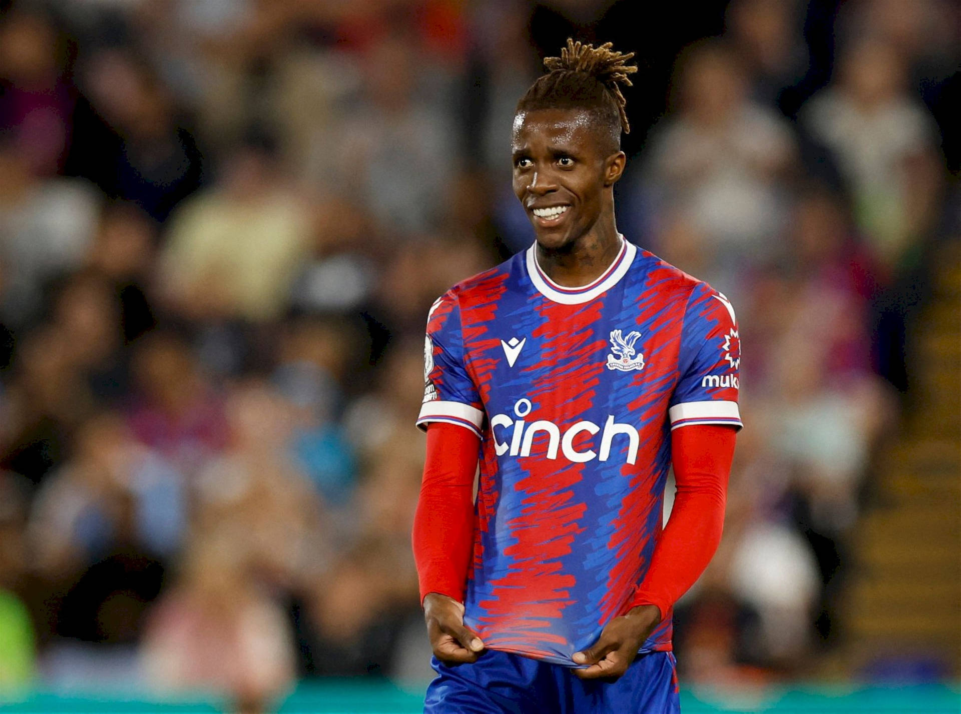 Wilfried Zaha Stretching His Shirt Background