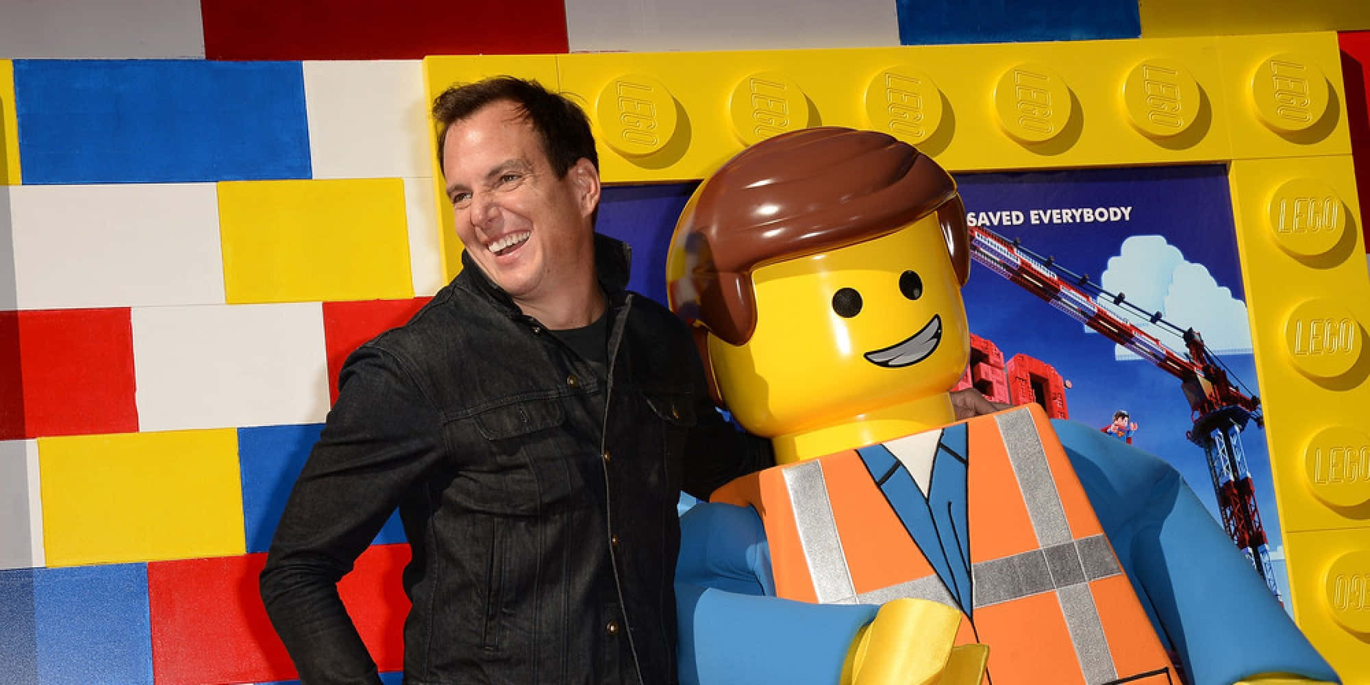 Will Arnett Striking A Pose In A Stylish Suit Background