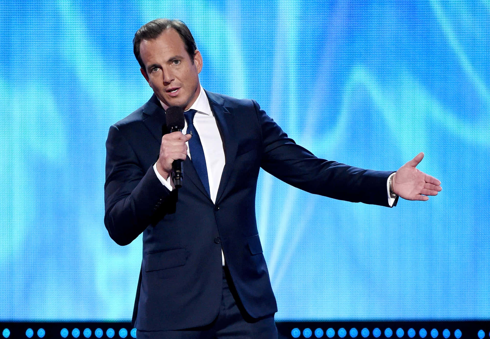 Will Arnett Striking A Pose In A Stylish Suit Background