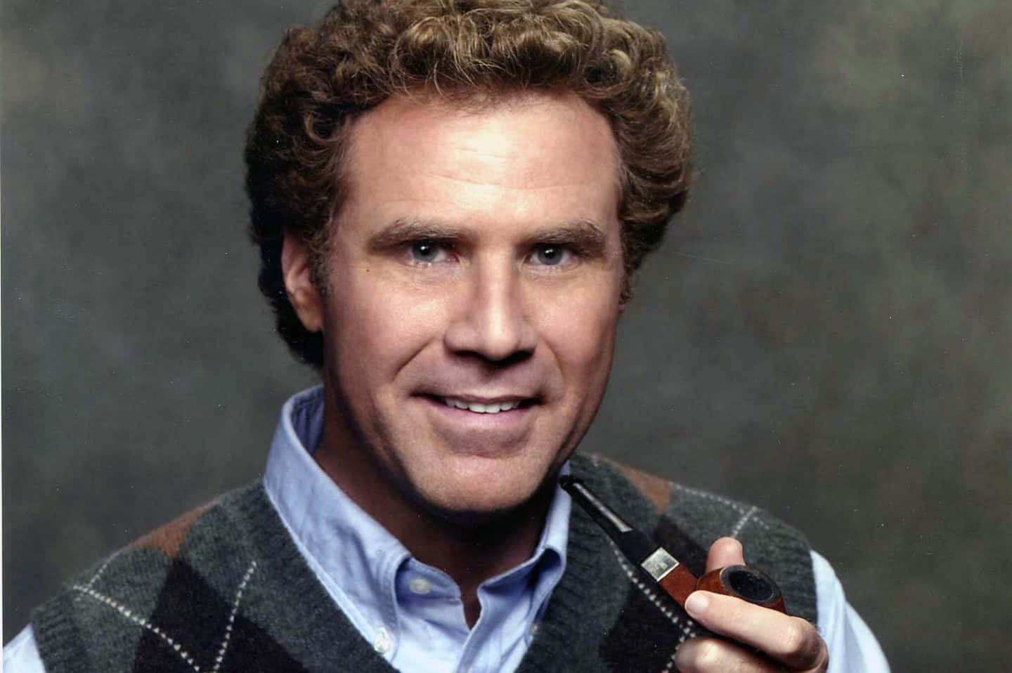 Will Ferrell Posing With Arms Crossed In A Suit Background