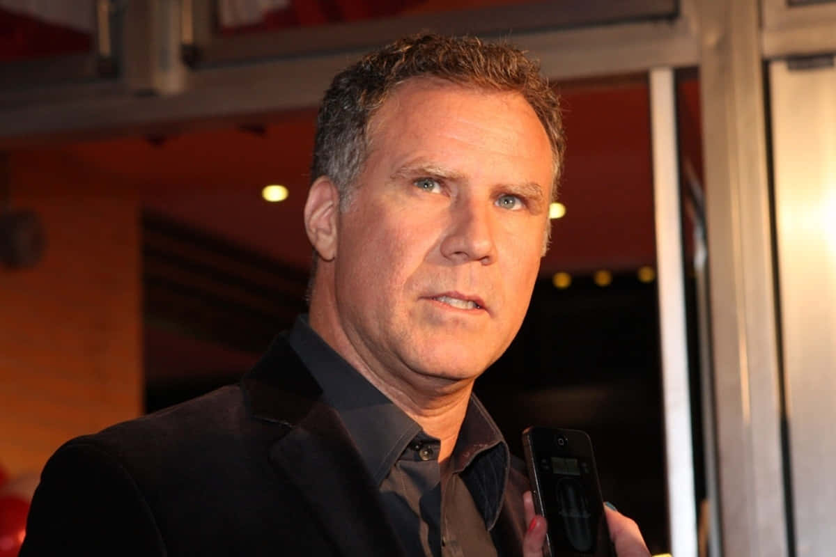 Will Ferrell Striking A Confident Pose On A Rooftop Background