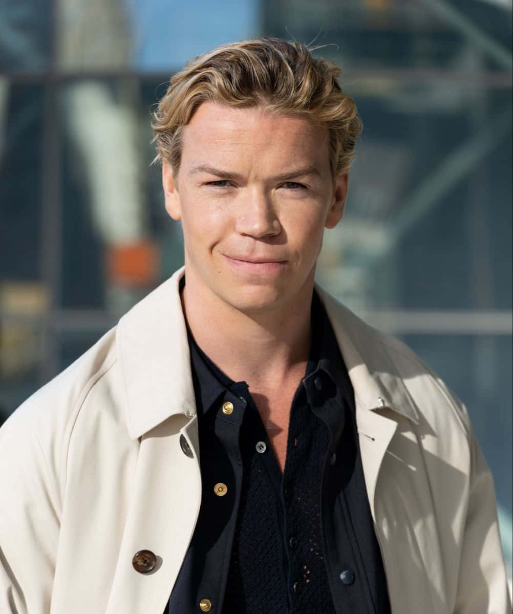 Will Poulter Smilingin Trench Coat Background