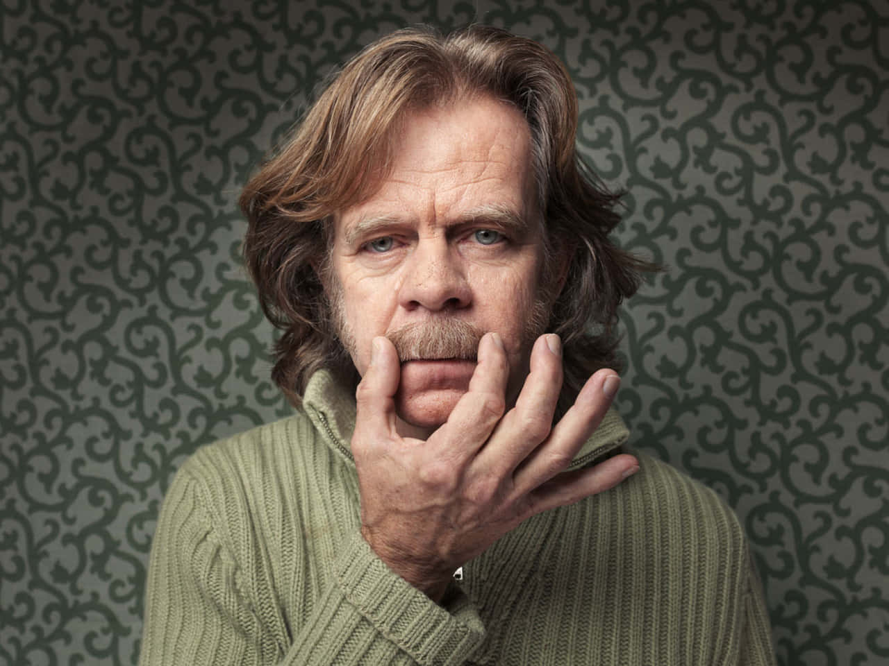 William H. Macy Smiling In Black Suit Background