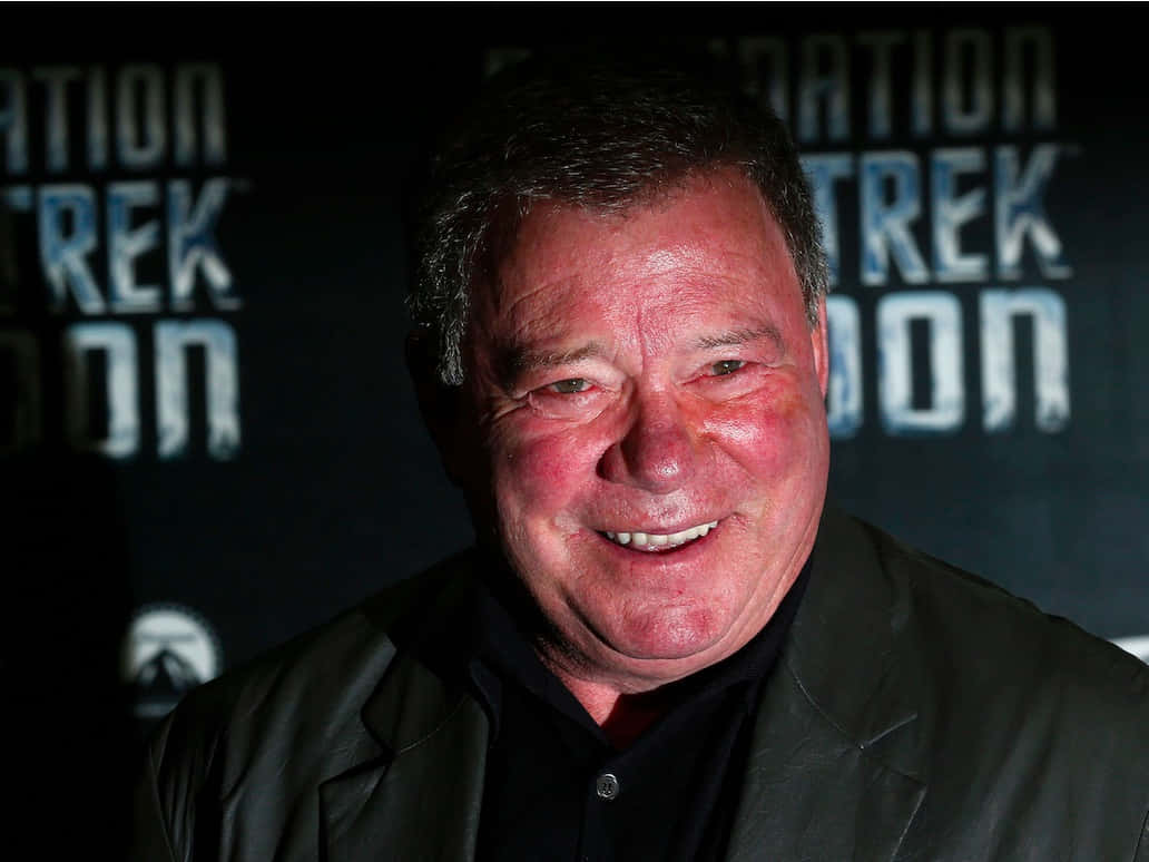 William Shatner Posing Elegantly Against A Backdrop Background