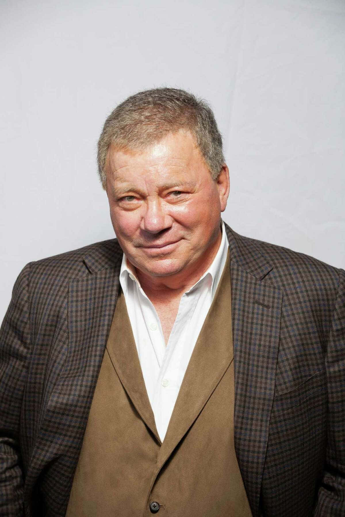William Shatner Standing With A Confident Expression Background