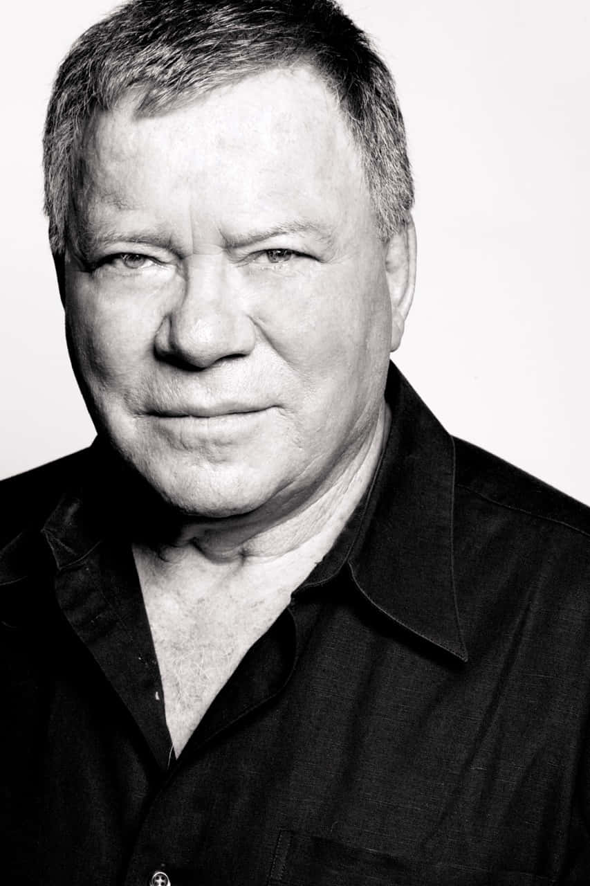 William Shatner Striking A Pose In A Black Suit And Tie