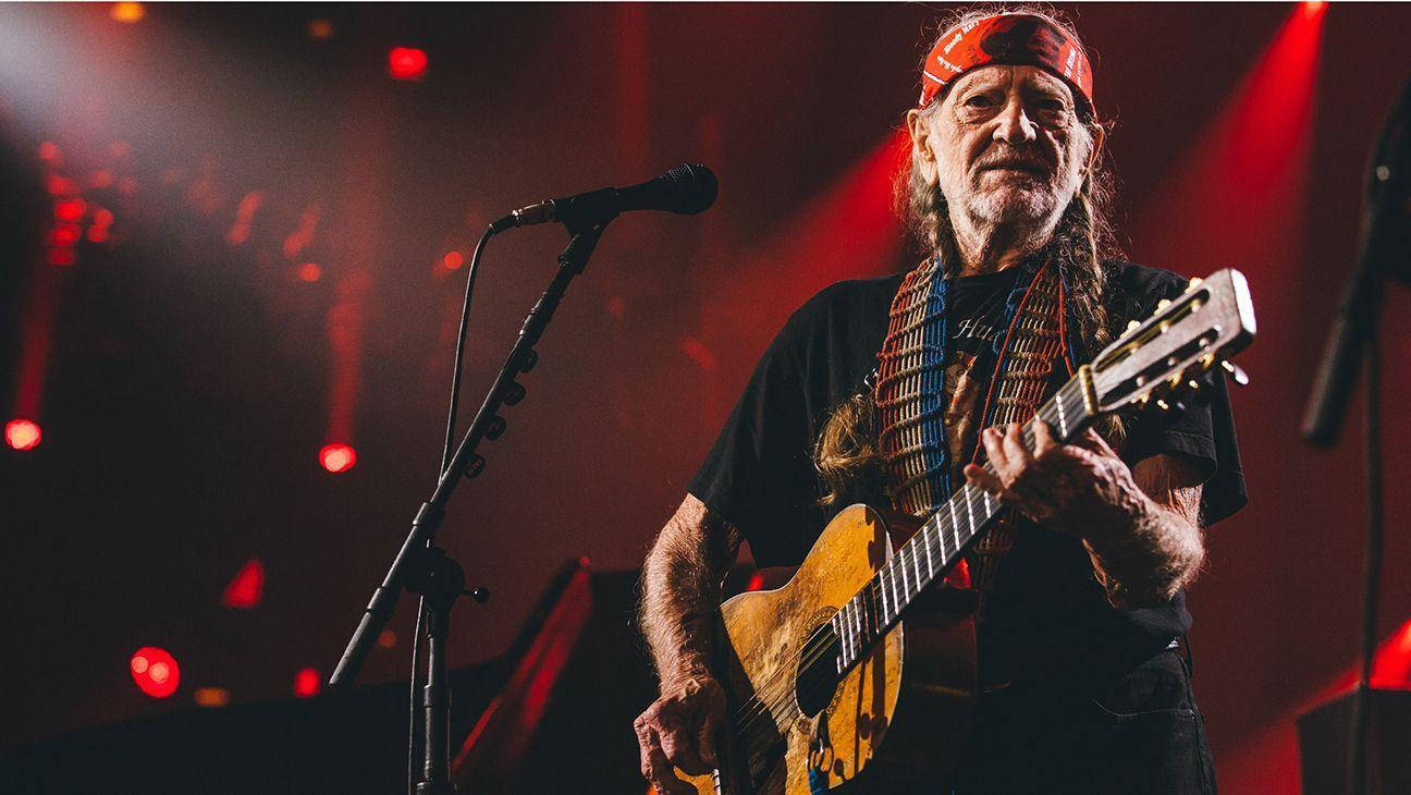 Willie Nelson On A Concert Performance Background