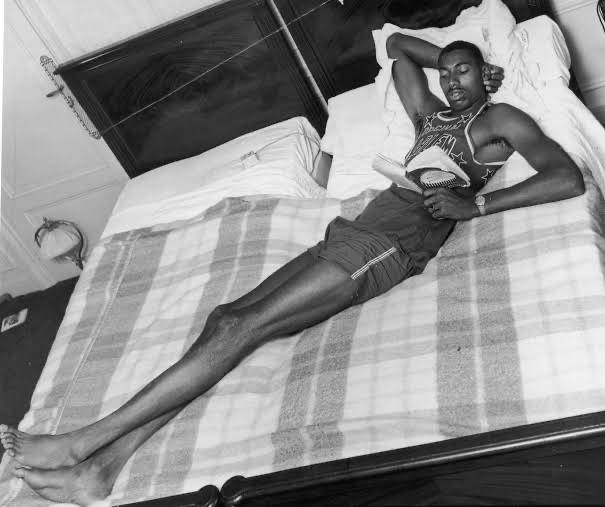Wilt Chamberlain On Bed Background