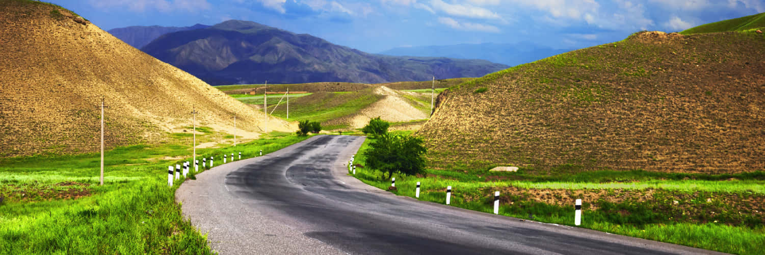 Winding Hillside Roads In Osh Background