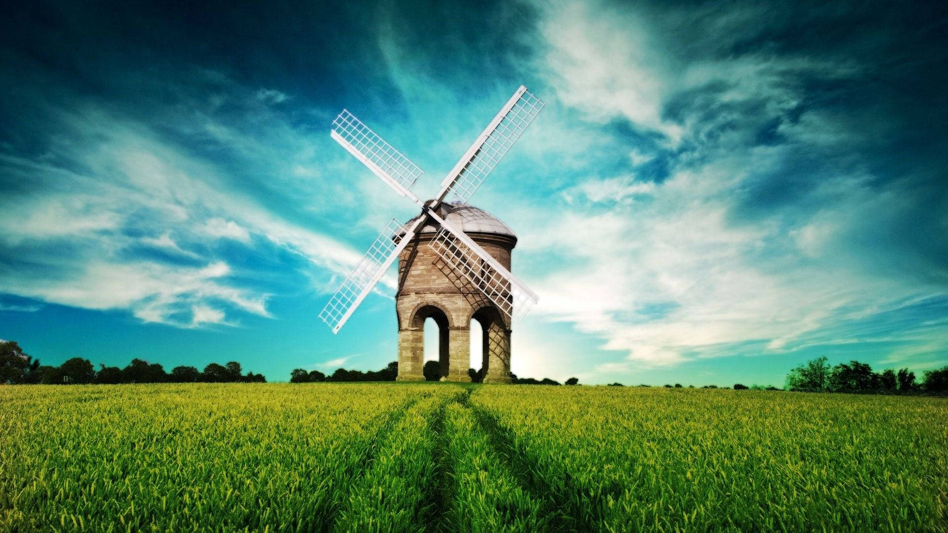 Windmill In Grass Field Background