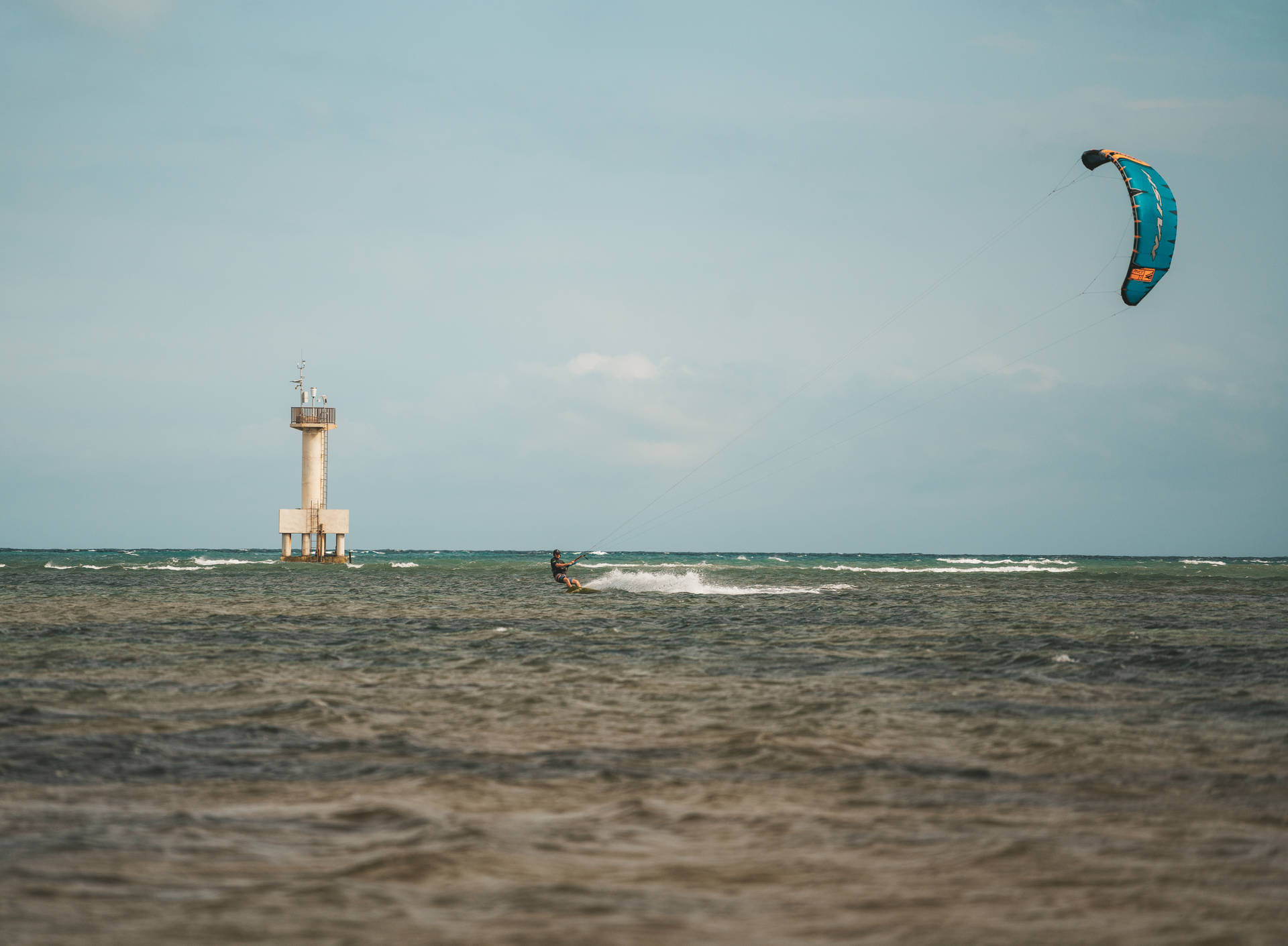 Windsurfing Near Lighthouse Background