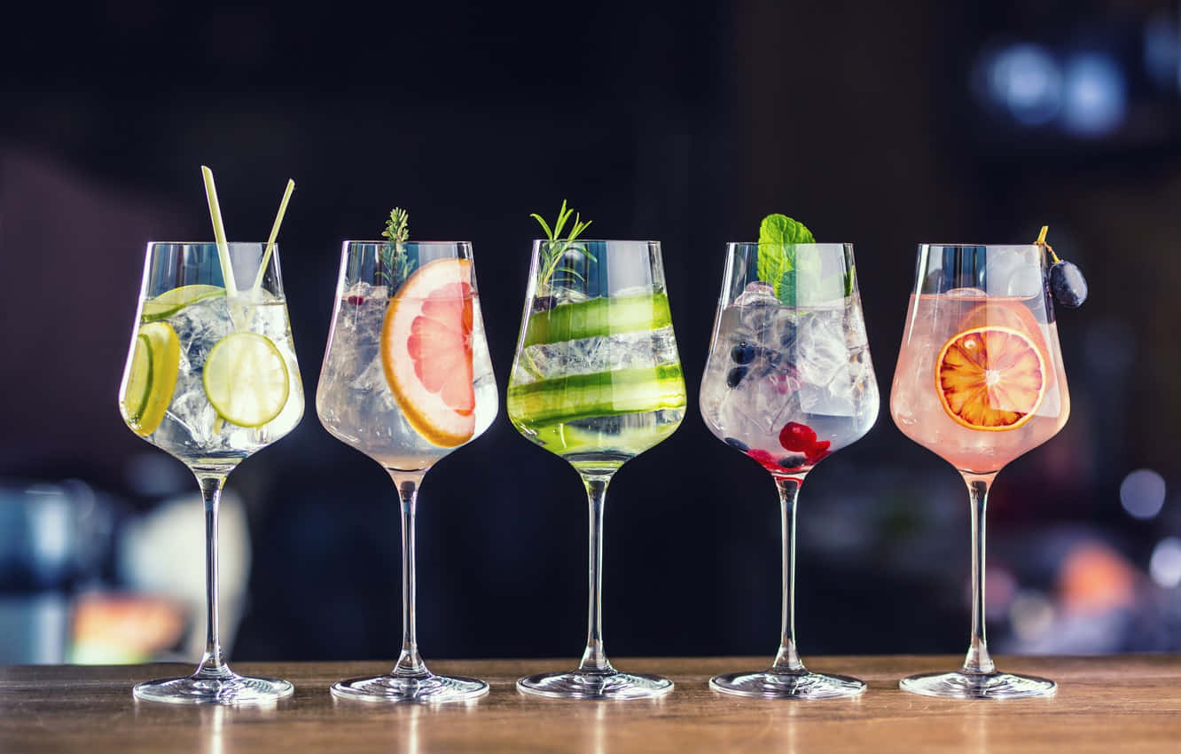 Wine Glasses With Fruit Cocktail Drinks On Bar Background