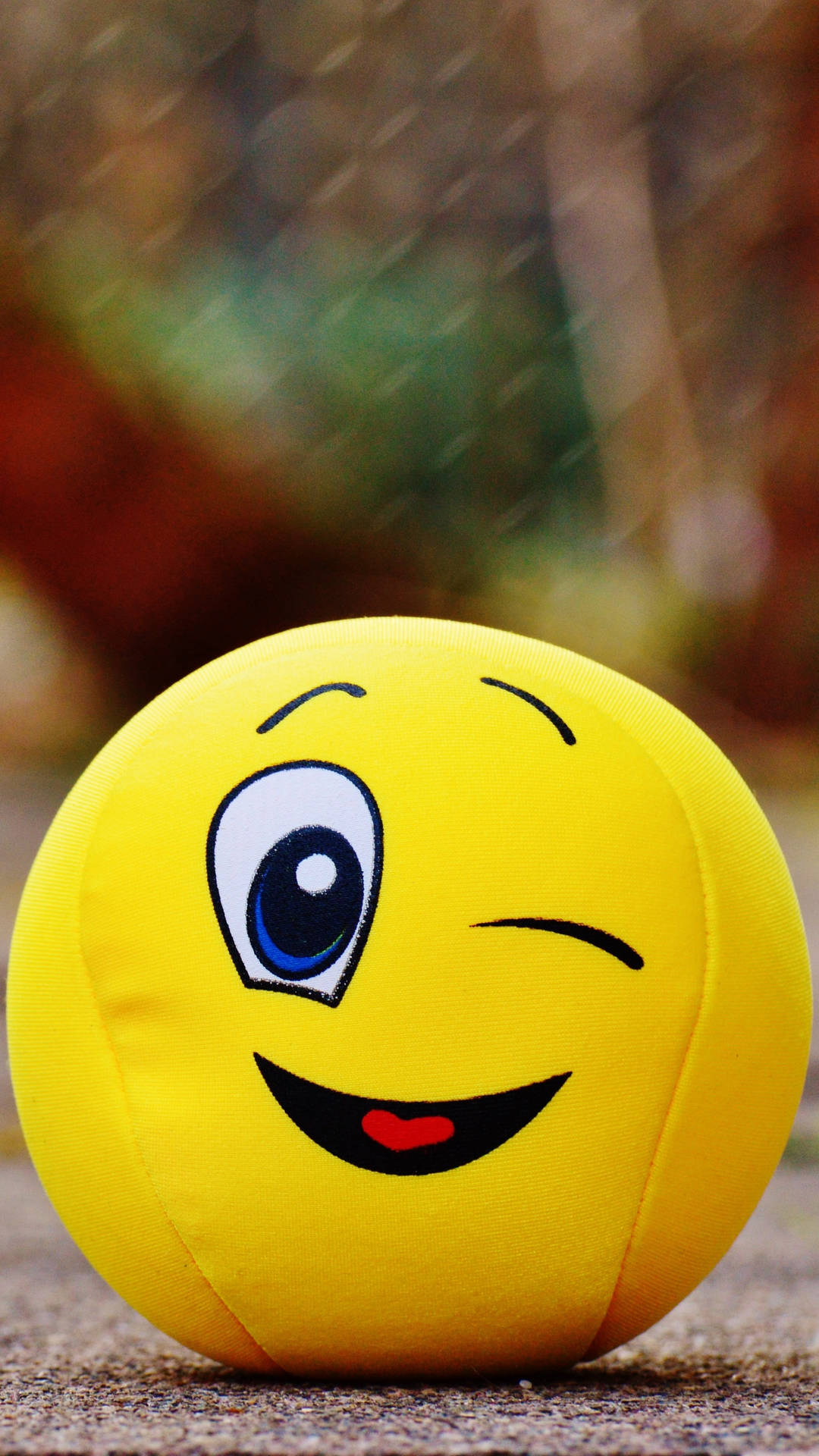 Winking Smiley Face Ball Cushion Background