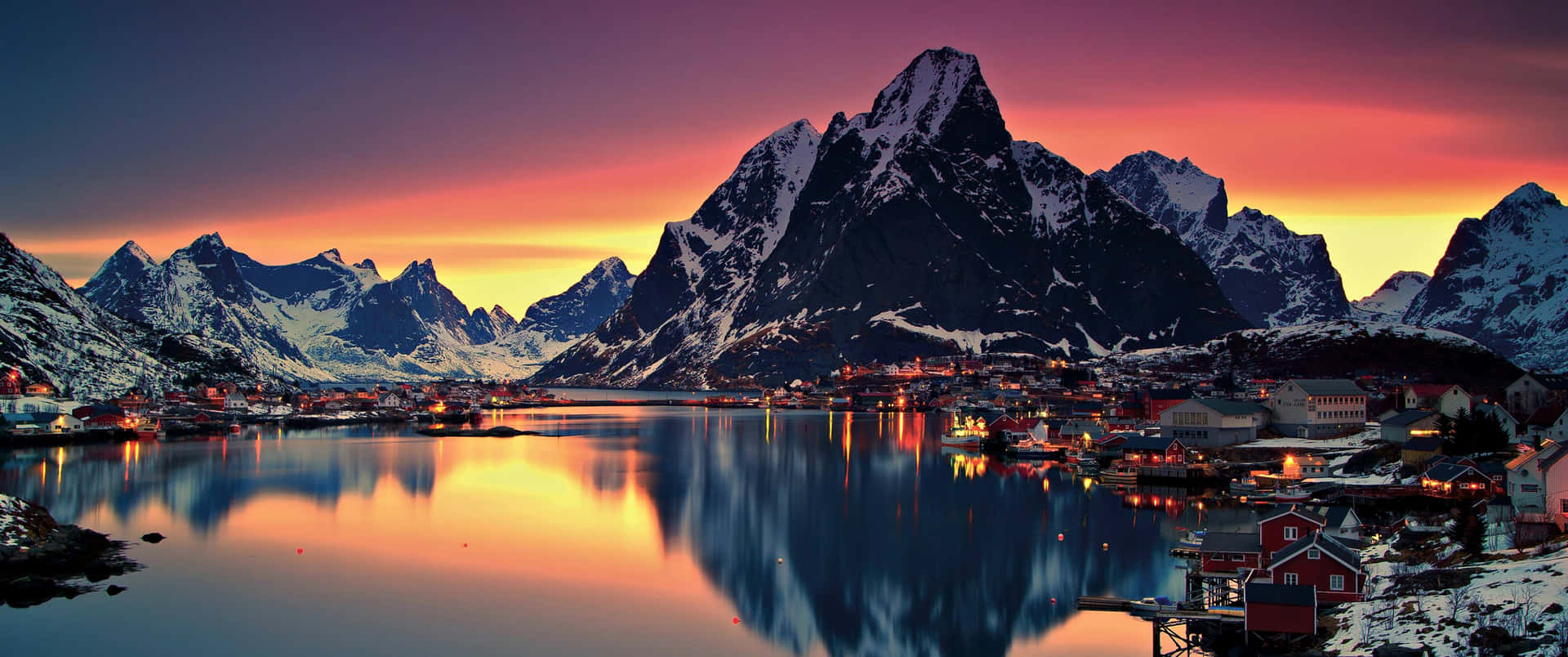 Winter View Of A Lonely Tree In Front Of The Snow-covered Mountains.