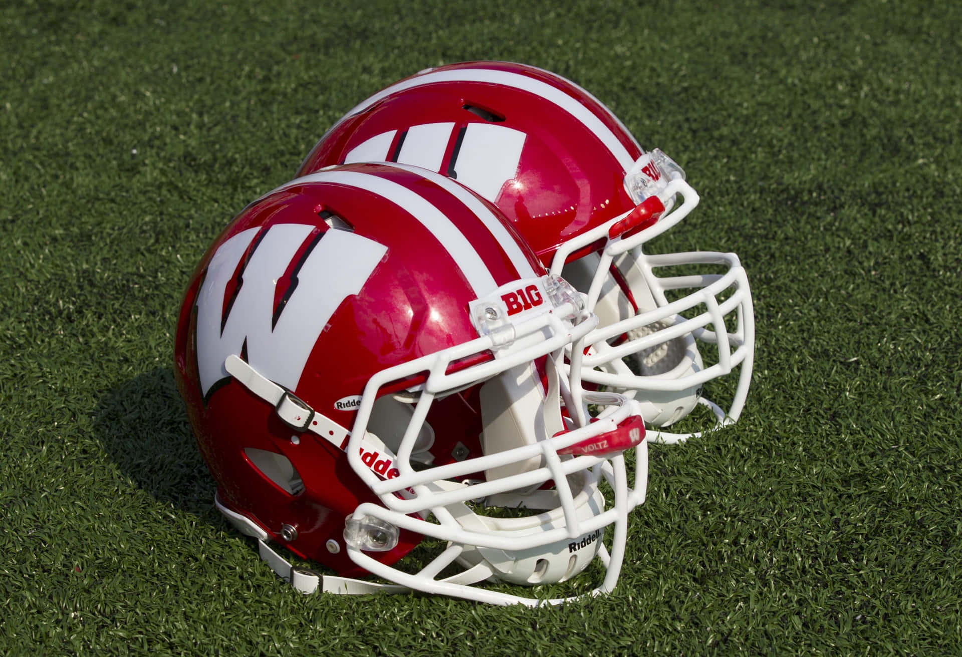 Wisconsin Badgers Football Team Charging Onto The Field Background