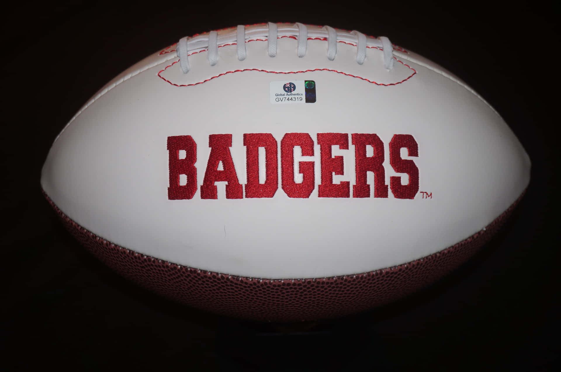 Wisconsin Badgers Football Team In Action Background