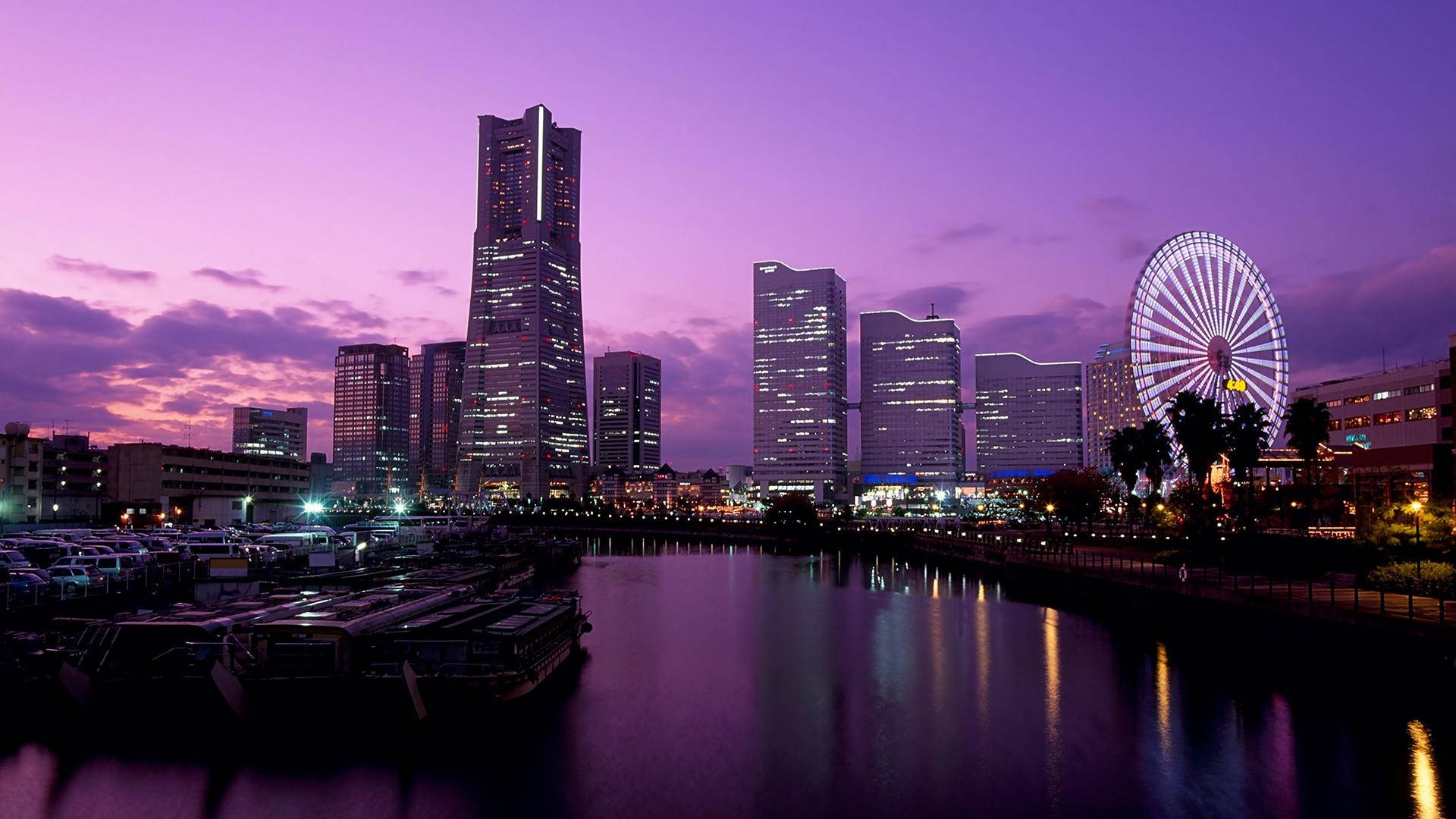 Witness The Breathtaking Beauty Of A Purple Sunset Cityscape. Background