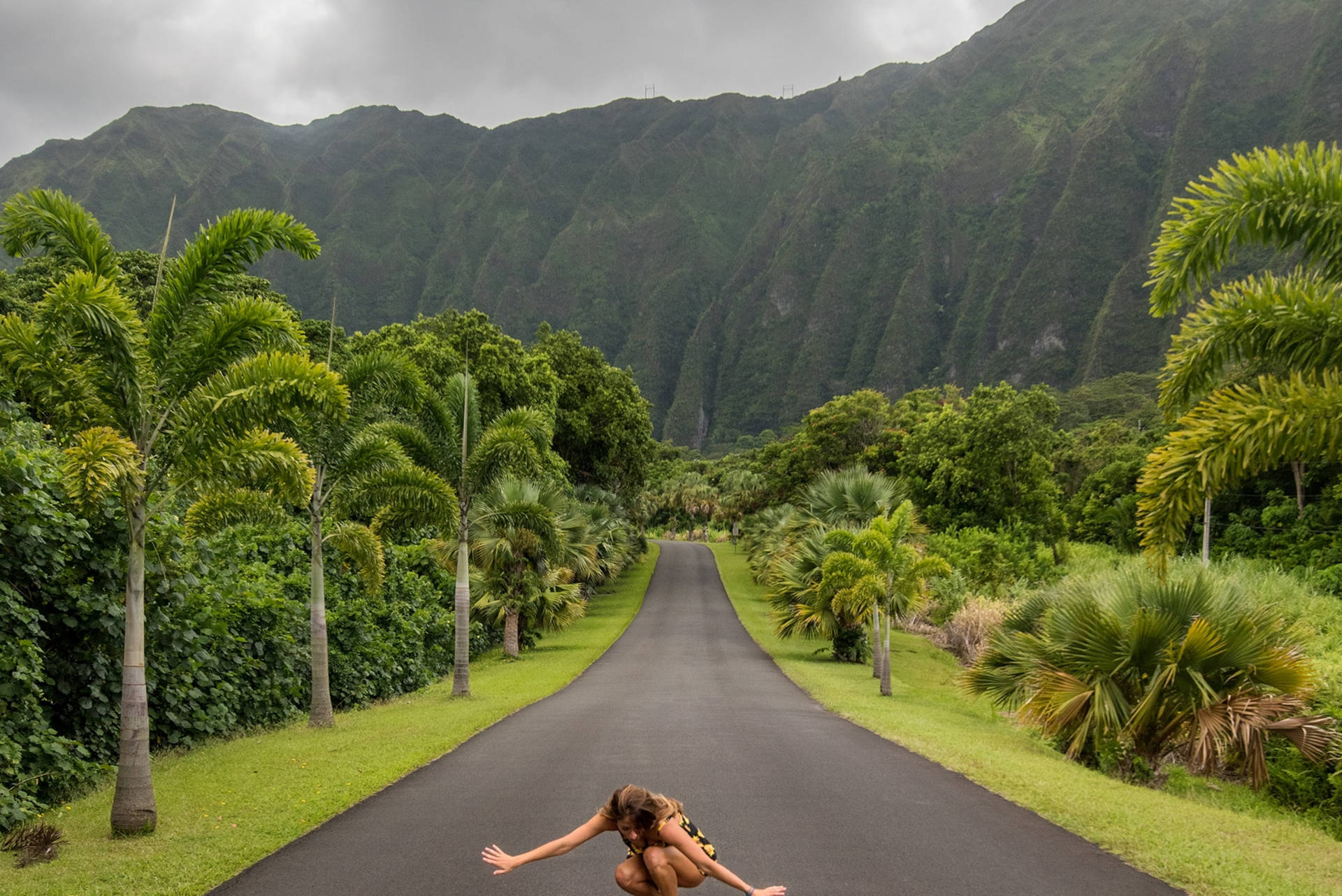 Woman Crouching In Oahu Botanical Garden