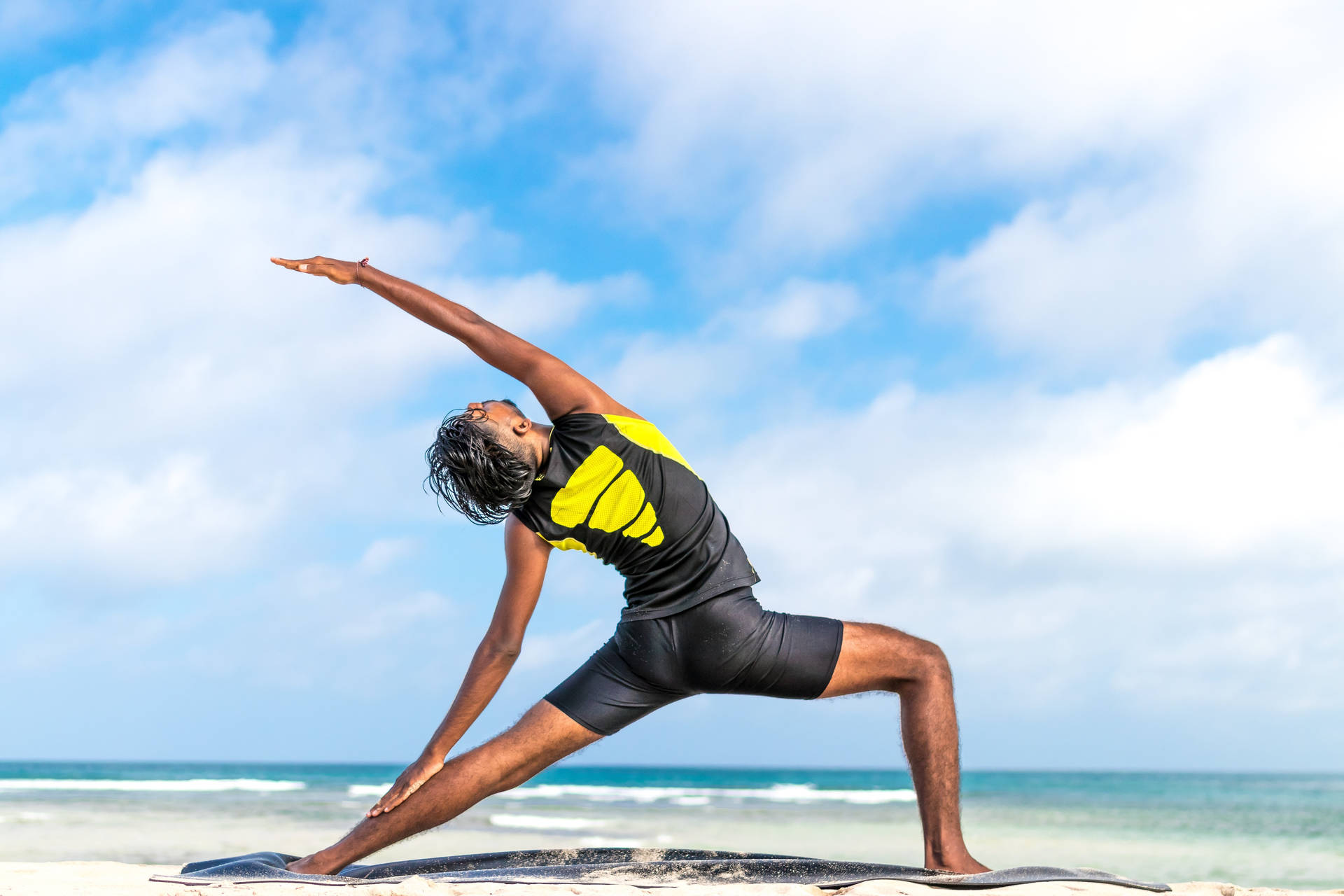 Woman Doing Pilates On Beach Background