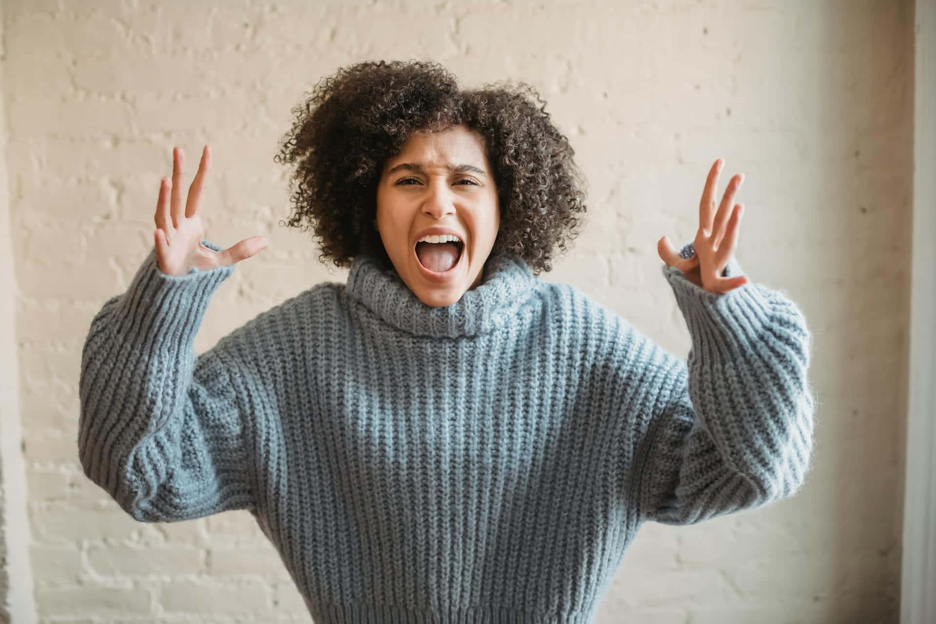 Woman Expressing Anger In Sweater Background