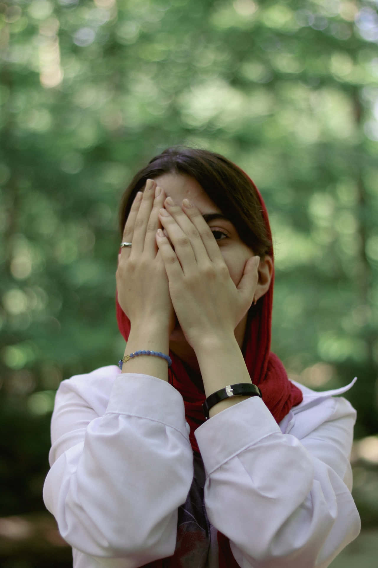 Woman Hiding Facein Forest Background