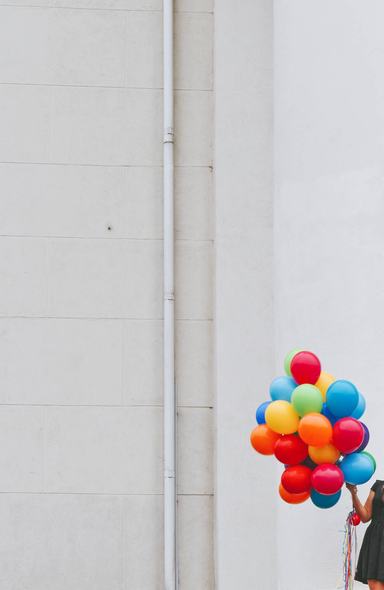 Woman Holding Bunch Of Colorful Balloons