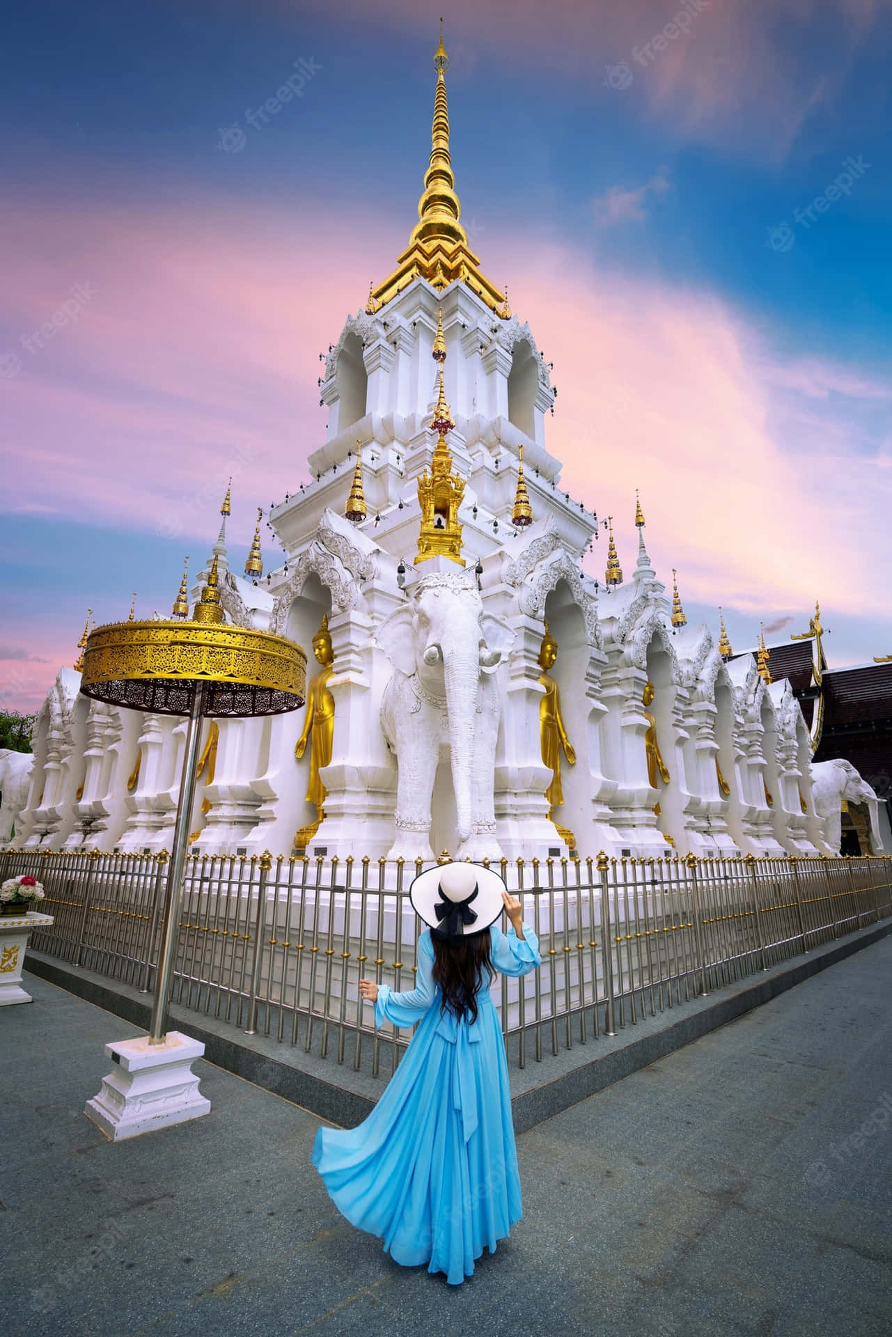 Woman In Blue In White Temple In Chiang Rai Background
