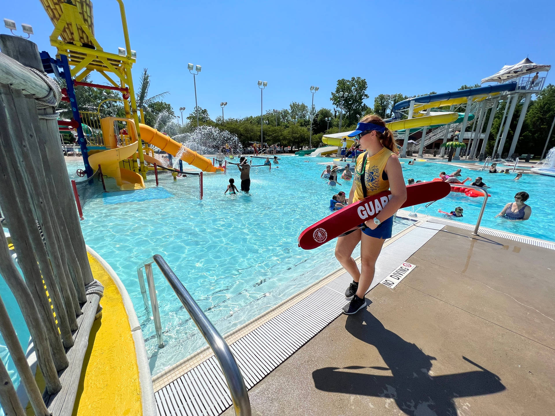 Woman Lifeguard Guarding The Poolside