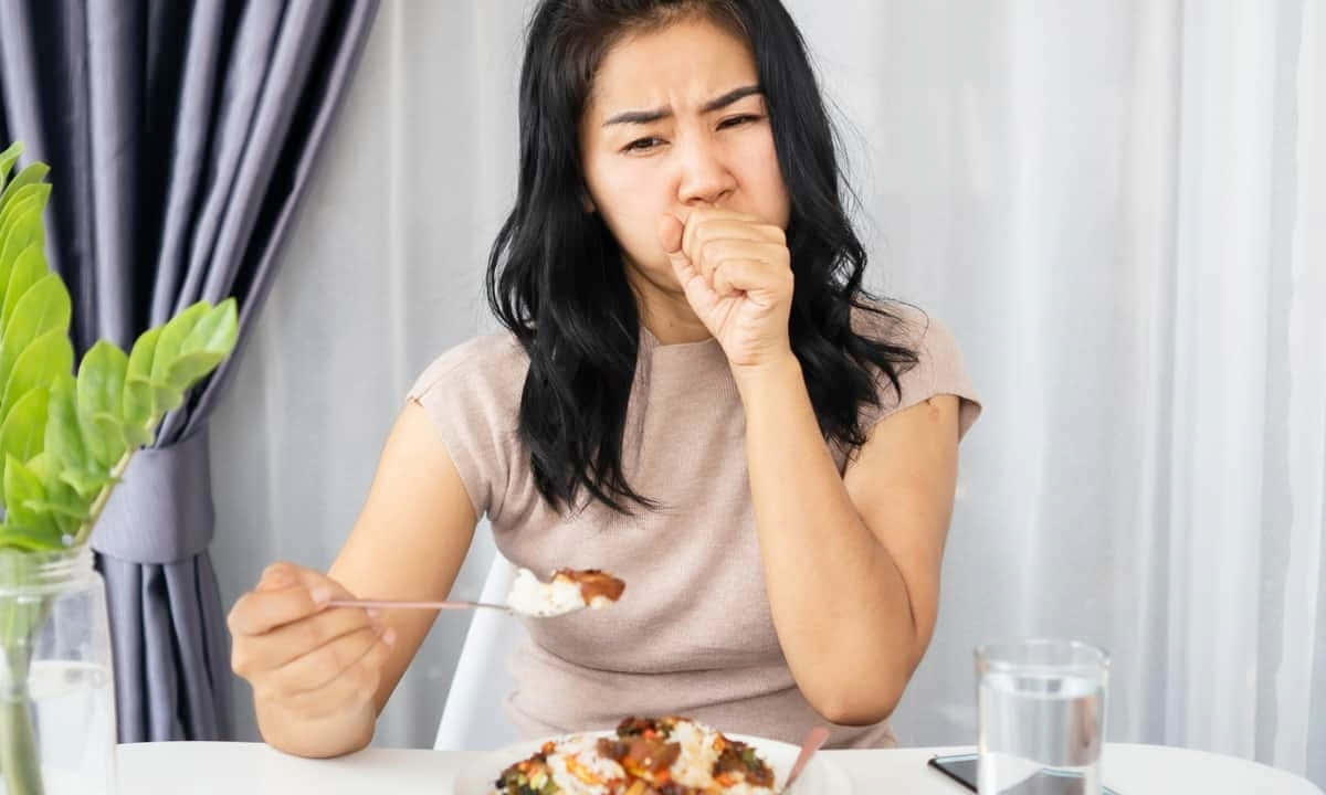 Woman Looking Nauseous While Eating