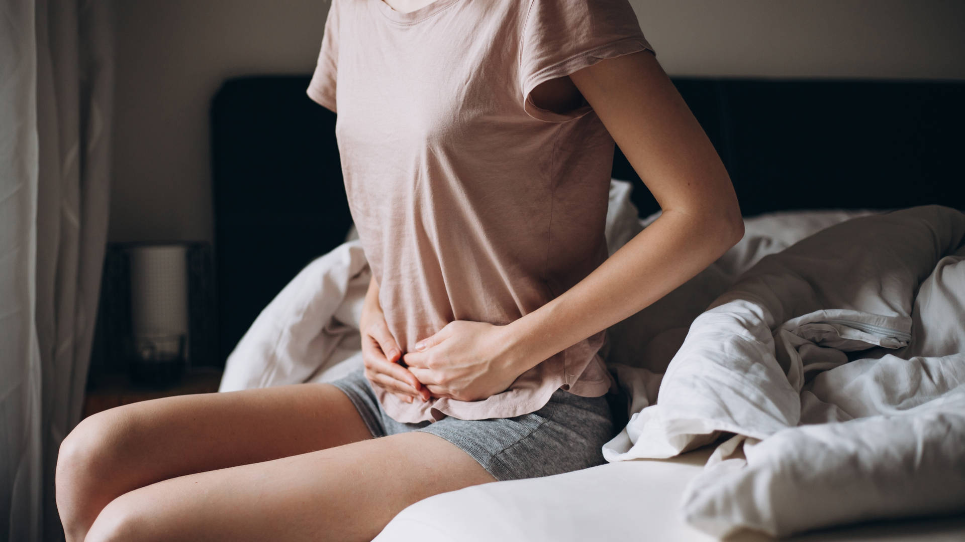 Woman On The Bed Feeling Nauseous Background